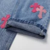 Jeans Chrome Hearts con logo croce rosa
